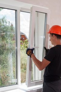Man installing window